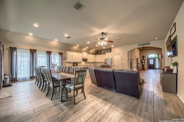 2097 Range Rd, Seguin, TX 78155 - dining area featuring light wood finished floors, recessed lighting, ceiling fan, visible vents, and arched walkways