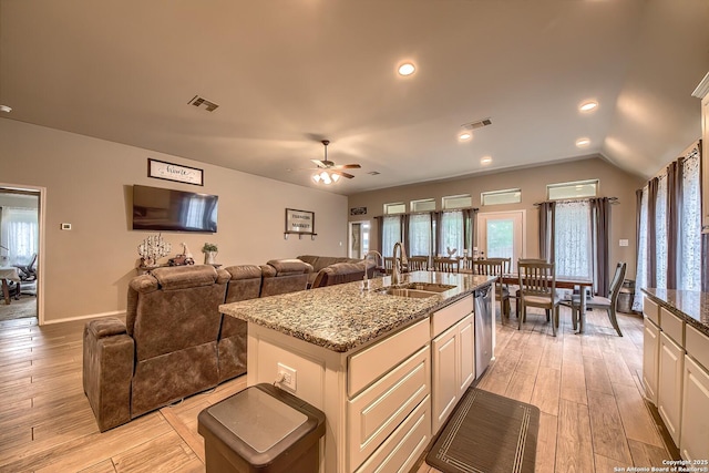 2097 Range Rd, Seguin, TX 78155 - kitchen with visible vents, light stone countertops, light wood finished floors, and a sink