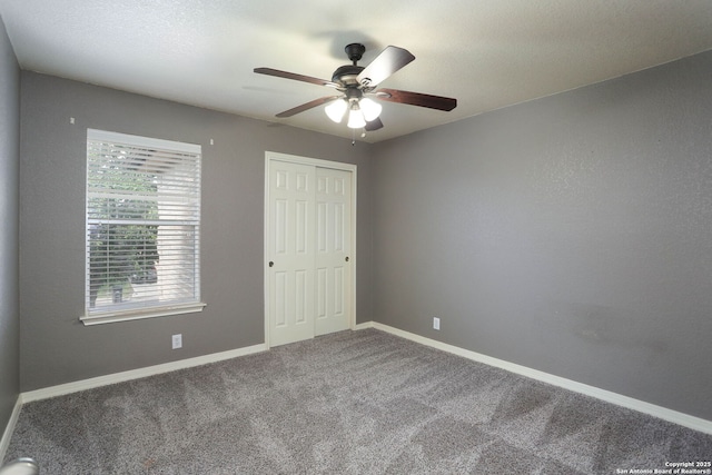 6819 Liberty Stone, San Antonio, TX 78244 - unfurnished bedroom featuring carpet, a closet, baseboards, and a ceiling fan