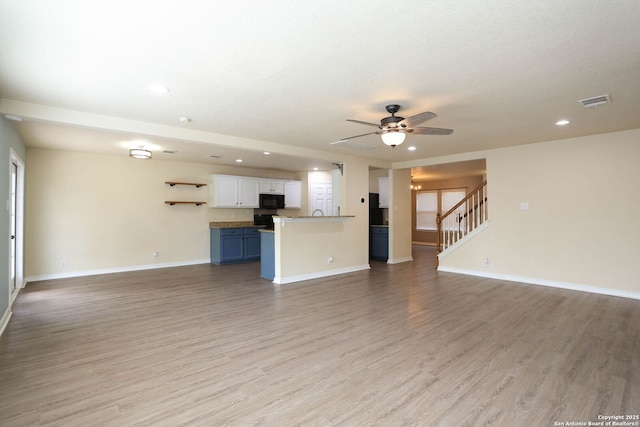 6819 Liberty Stone, San Antonio, TX 78244 - unfurnished living room featuring ceiling fan, light wood finished floors, baseboards, and recessed lighting