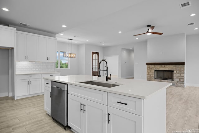 kitchen featuring visible vents, ceiling fan, dishwasher, and a sink
