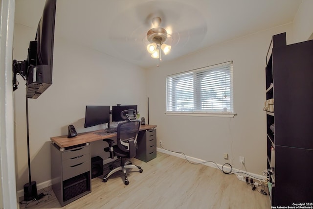 home office featuring ceiling fan, baseboards, and light wood-style floors