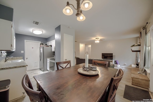 dining space with visible vents and a chandelier