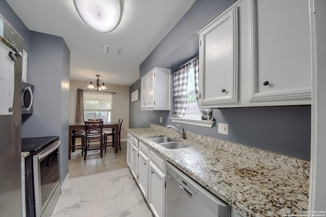 kitchen with white cabinetry, visible vents, appliances with stainless steel finishes, and a sink