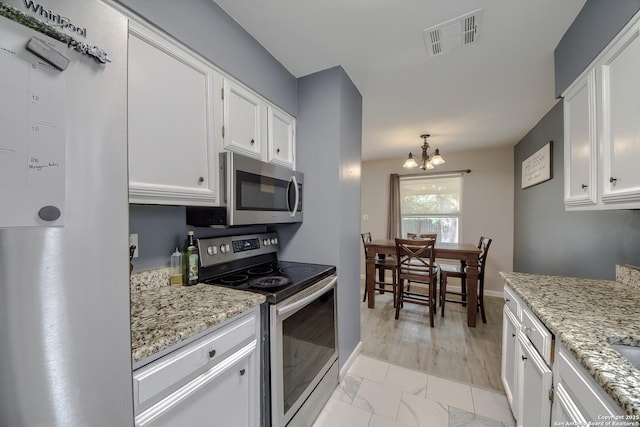 kitchen with white cabinets, visible vents, appliances with stainless steel finishes, and marble finish floor