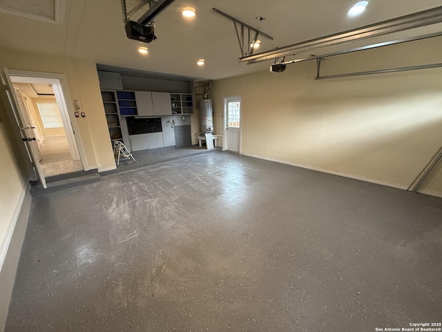 garage with recessed lighting, water heater, a garage door opener, and baseboards