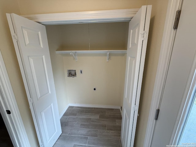 laundry room featuring electric dryer hookup, baseboards, hookup for a washing machine, wood finish floors, and laundry area