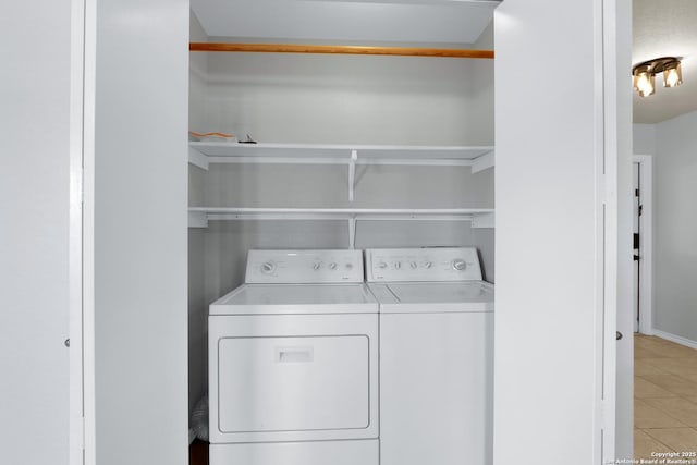 laundry area with light tile patterned flooring, independent washer and dryer, and laundry area