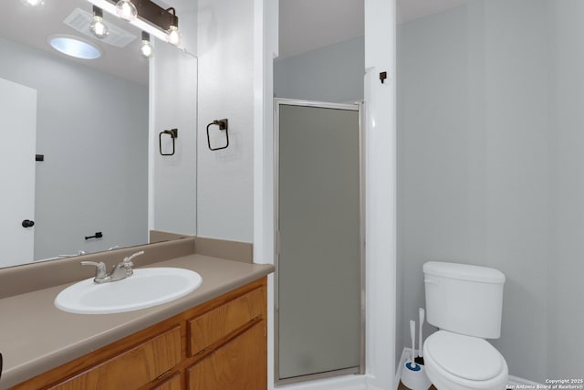 full bath featuring a stall shower, toilet, and vanity