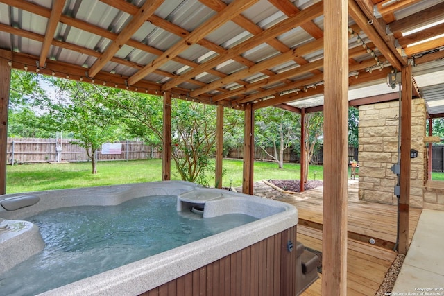 deck featuring a yard, a fenced backyard, and a hot tub
