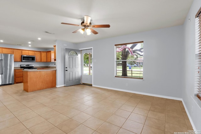 kitchen featuring light tile patterned floors, visible vents, ceiling fan, and appliances with stainless steel finishes