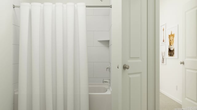 full bath featuring shower / bath combo, radiator heating unit, and baseboards