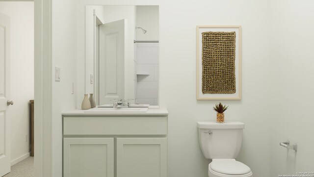 bathroom featuring toilet, vanity, and baseboards