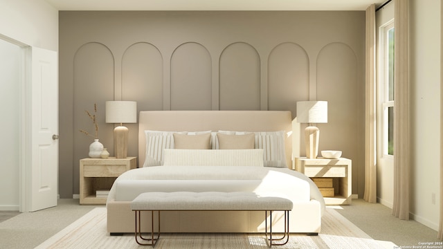 bedroom featuring light colored carpet and baseboards