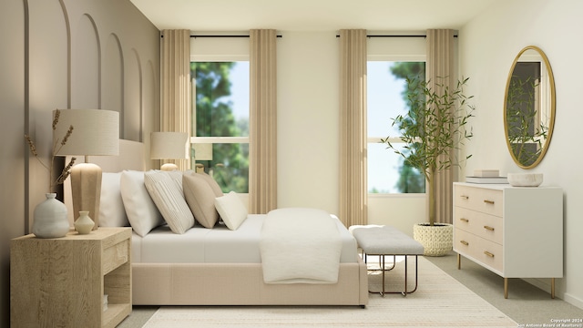 bedroom featuring light carpet and multiple windows