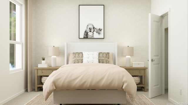 bedroom featuring light colored carpet and baseboards
