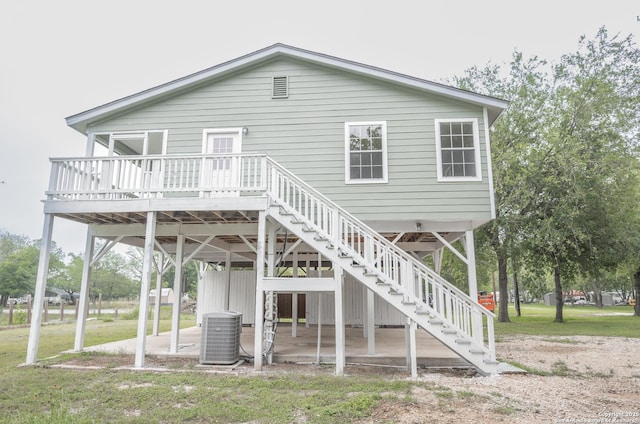 back of house featuring a patio, a wooden deck, stairway, a yard, and central AC