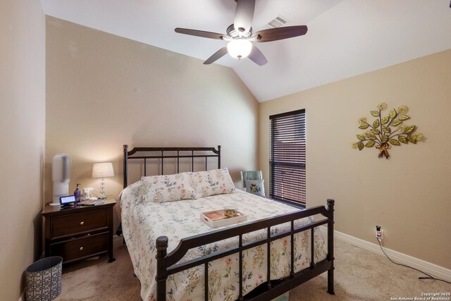 bedroom featuring lofted ceiling, visible vents, ceiling fan, baseboards, and carpet