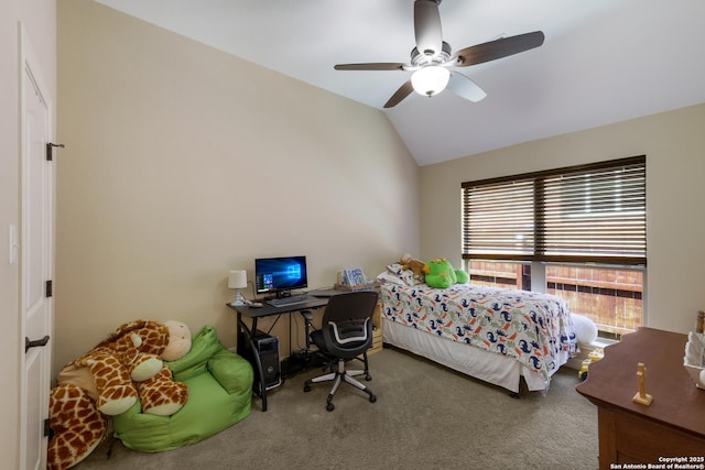 carpeted bedroom with a ceiling fan and vaulted ceiling