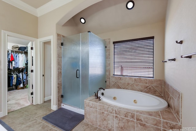 full bathroom with a shower stall, a whirlpool tub, ornamental molding, a spacious closet, and tile patterned flooring