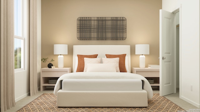 bedroom with baseboards and light carpet