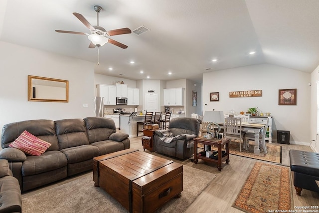 living area with recessed lighting, a ceiling fan, visible vents, light wood-style flooring, and vaulted ceiling