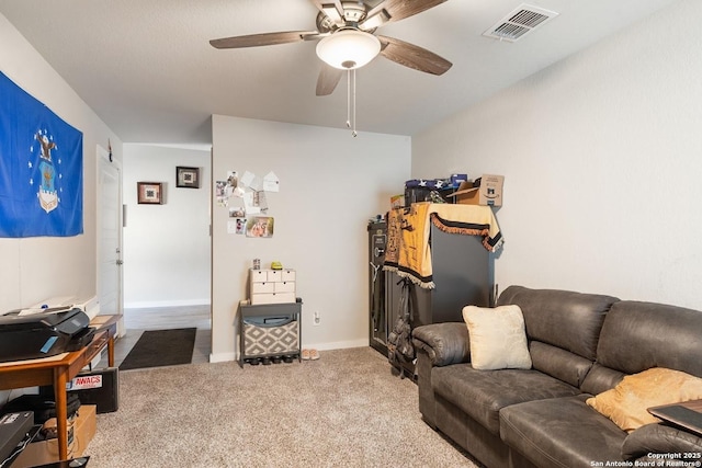 carpeted living area featuring ceiling fan, baseboards, and visible vents