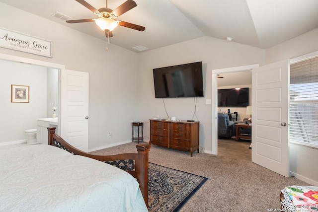 bedroom featuring ensuite bath, carpet floors, baseboards, visible vents, and lofted ceiling