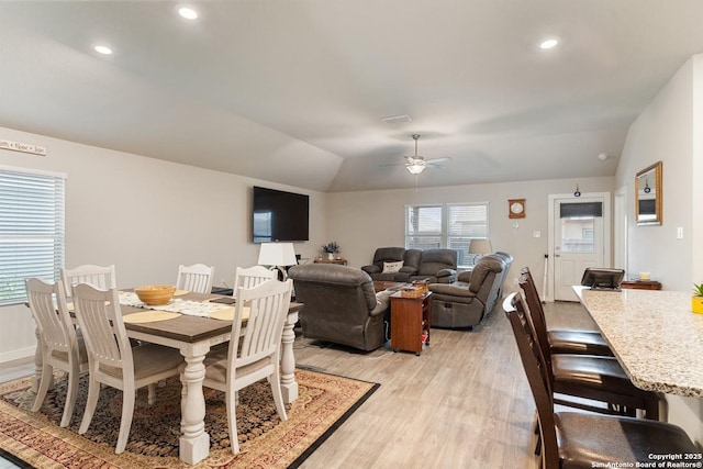 dining space featuring lofted ceiling, light wood-style floors, ceiling fan, and recessed lighting