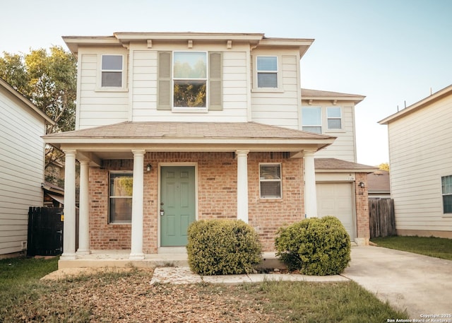 view of front of home with roof with shingles, concrete driveway, a porch, and brick siding