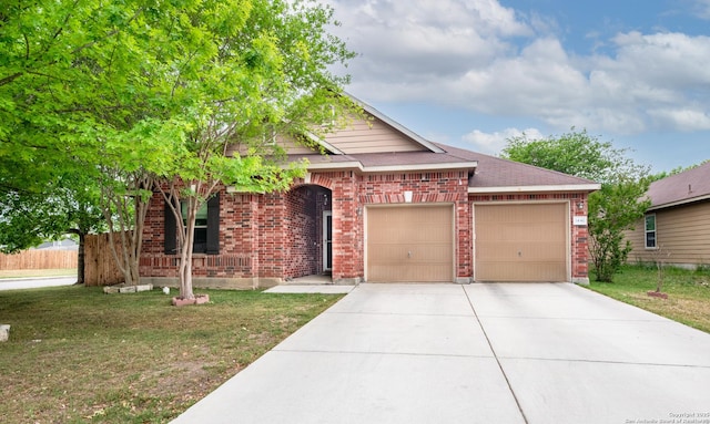 view of front of house featuring a front yard, a garage, driveway, brick siding, and fence