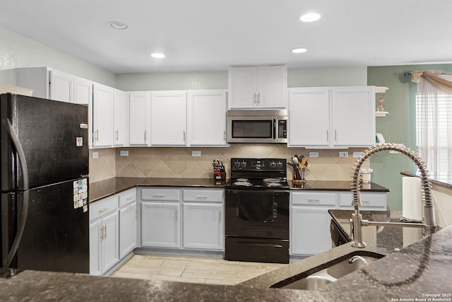 kitchen featuring recessed lighting, decorative backsplash, dark stone counters, white cabinets, and black appliances