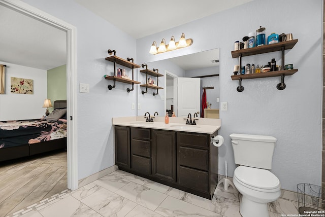 bathroom with double vanity, toilet, ensuite bath, and a sink