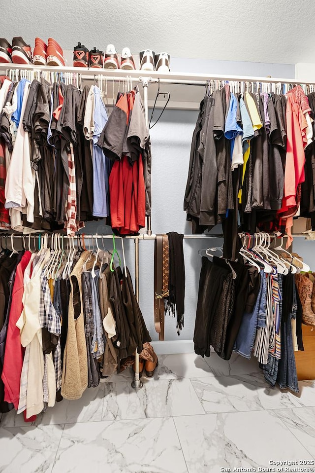 spacious closet with marble finish floor