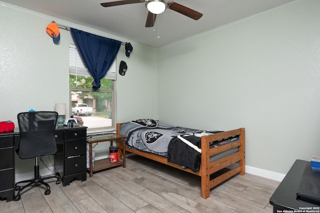bedroom featuring baseboards, a ceiling fan, and light wood-style floors