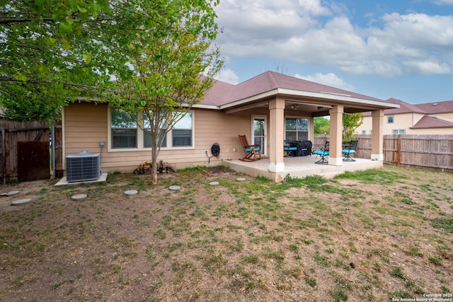 back of house featuring central air condition unit, a patio, and a fenced backyard
