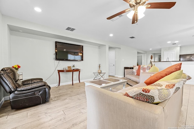 living area featuring recessed lighting, light wood finished floors, baseboards, visible vents, and a ceiling fan