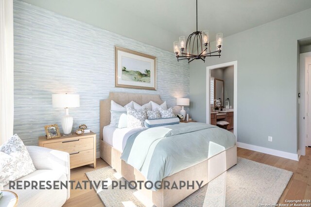 349 Hulda, New Braunfels, TX 78130 - bedroom with an inviting chandelier, wood finished floors, ensuite bath, and baseboards