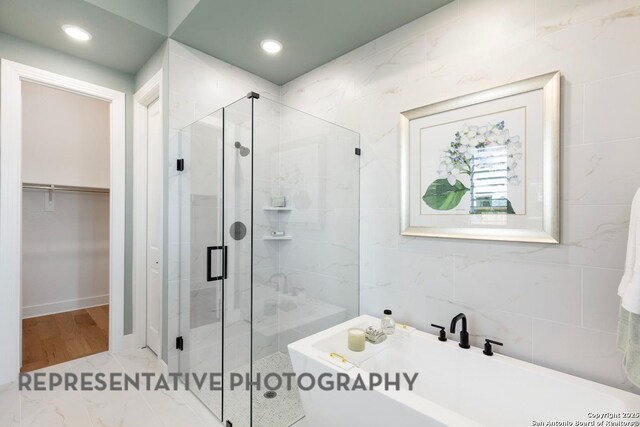 349 Hulda, New Braunfels, TX 78130 - bathroom featuring tile walls, a walk in closet, a shower stall, and a soaking tub