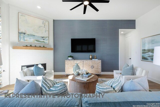 349 Hulda, New Braunfels, TX 78130 - living room featuring baseboards, an accent wall, wood finished floors, and a ceiling fan
