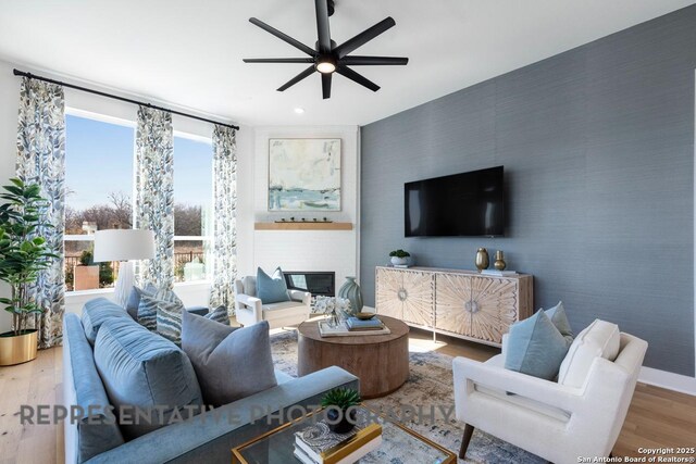 349 Hulda, New Braunfels, TX 78130 - living area featuring recessed lighting, wood finished floors, wallpapered walls, an accent wall, and a ceiling fan
