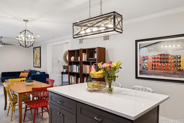 dining area featuring ornamental molding and a notable chandelier