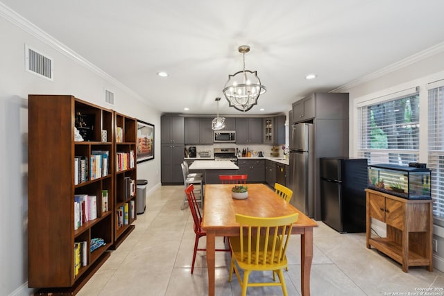 dining space with visible vents, ornamental molding, and a chandelier
