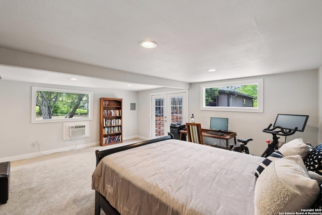 carpeted bedroom with multiple windows, french doors, a wall mounted AC, baseboards, and recessed lighting