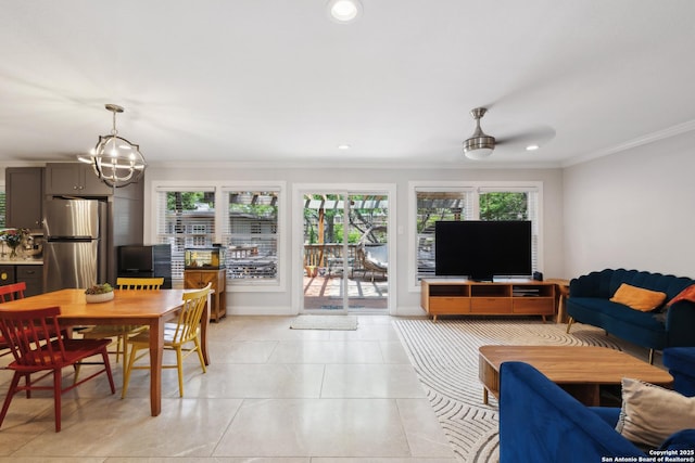 living room featuring recessed lighting, a notable chandelier, ornamental molding, and a wealth of natural light