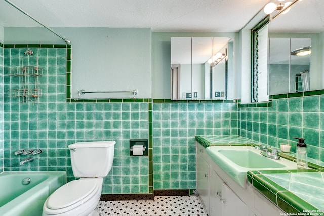 full bathroom with tile walls, shower / bathing tub combination, toilet, and vanity