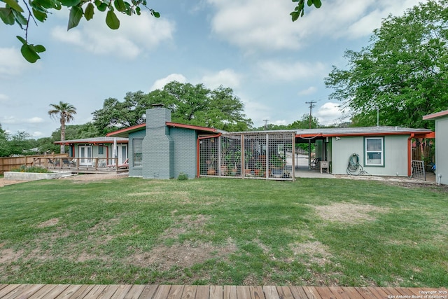 back of house with a patio, fence, a chimney, and a yard