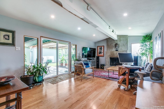 living area featuring wood finished floors, lofted ceiling with beams, and recessed lighting