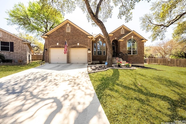 view of front facade with a front yard, a garage, brick siding, concrete driveway, and fence