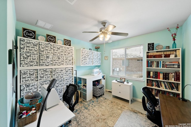 carpeted office space with a ceiling fan, visible vents, and baseboards